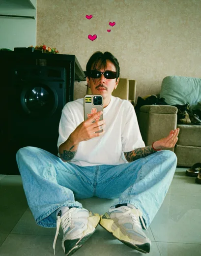 Dakota sitting for a mirror selfie in Bangkok in 2026